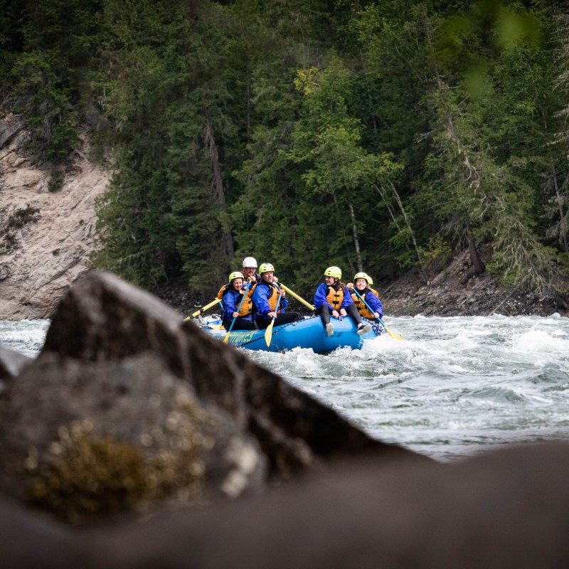 a group of people riding skis on a raft