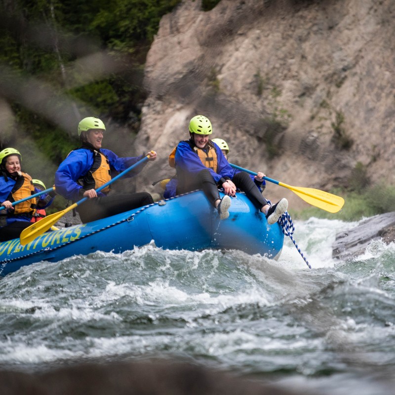 a man riding on a raft in a body of water