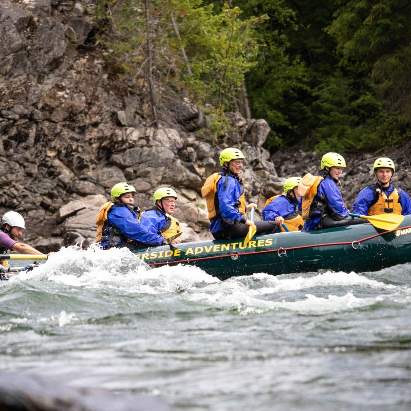 a group of people riding on a raft in a body of water