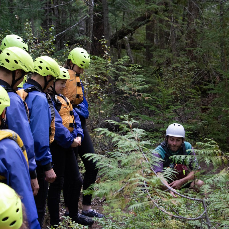 a group of people riding on the back of a person wearing a helmet