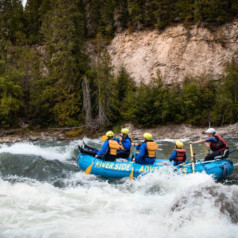 a group of people riding on a raft in the water