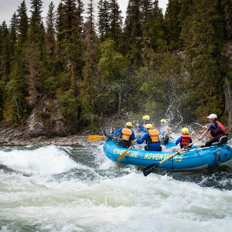 a person riding on the back of a boat in the water