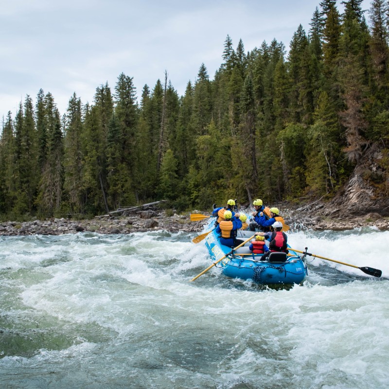 a man riding on a raft in a body of water