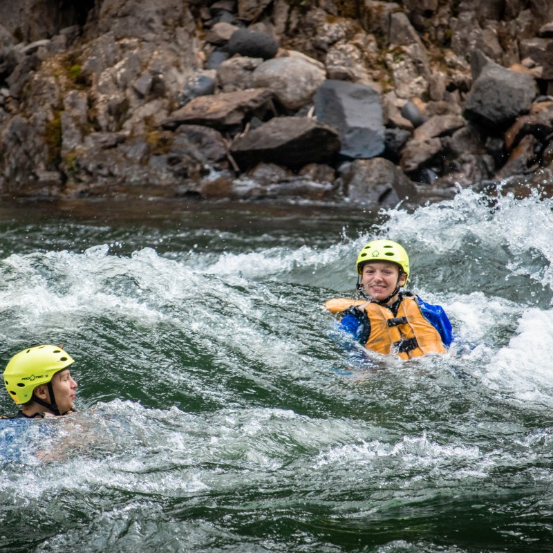 a man riding a wave on a surf board on a body of water