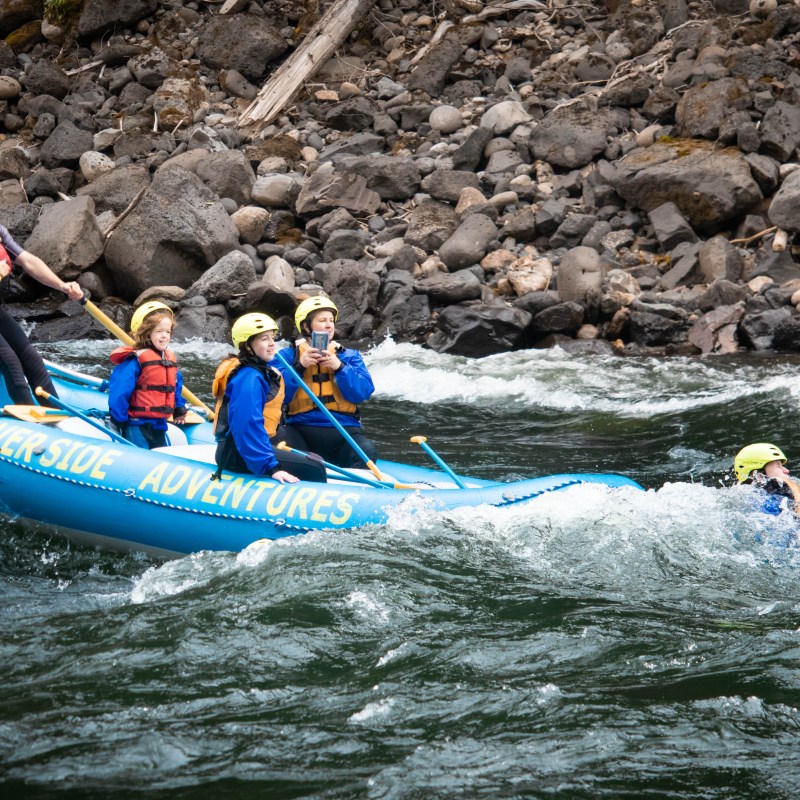 a group of people riding on a raft in a body of water