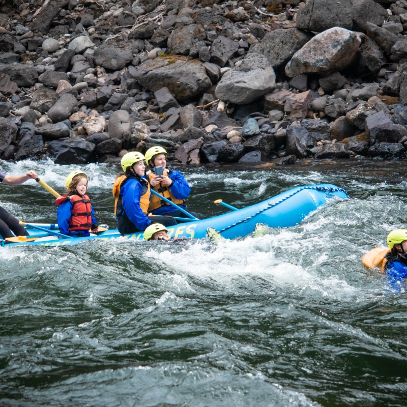 a group of people riding on a raft in the water