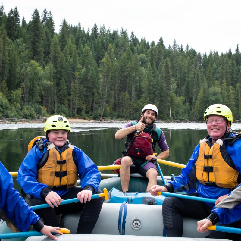 a group of people sitting on a raft