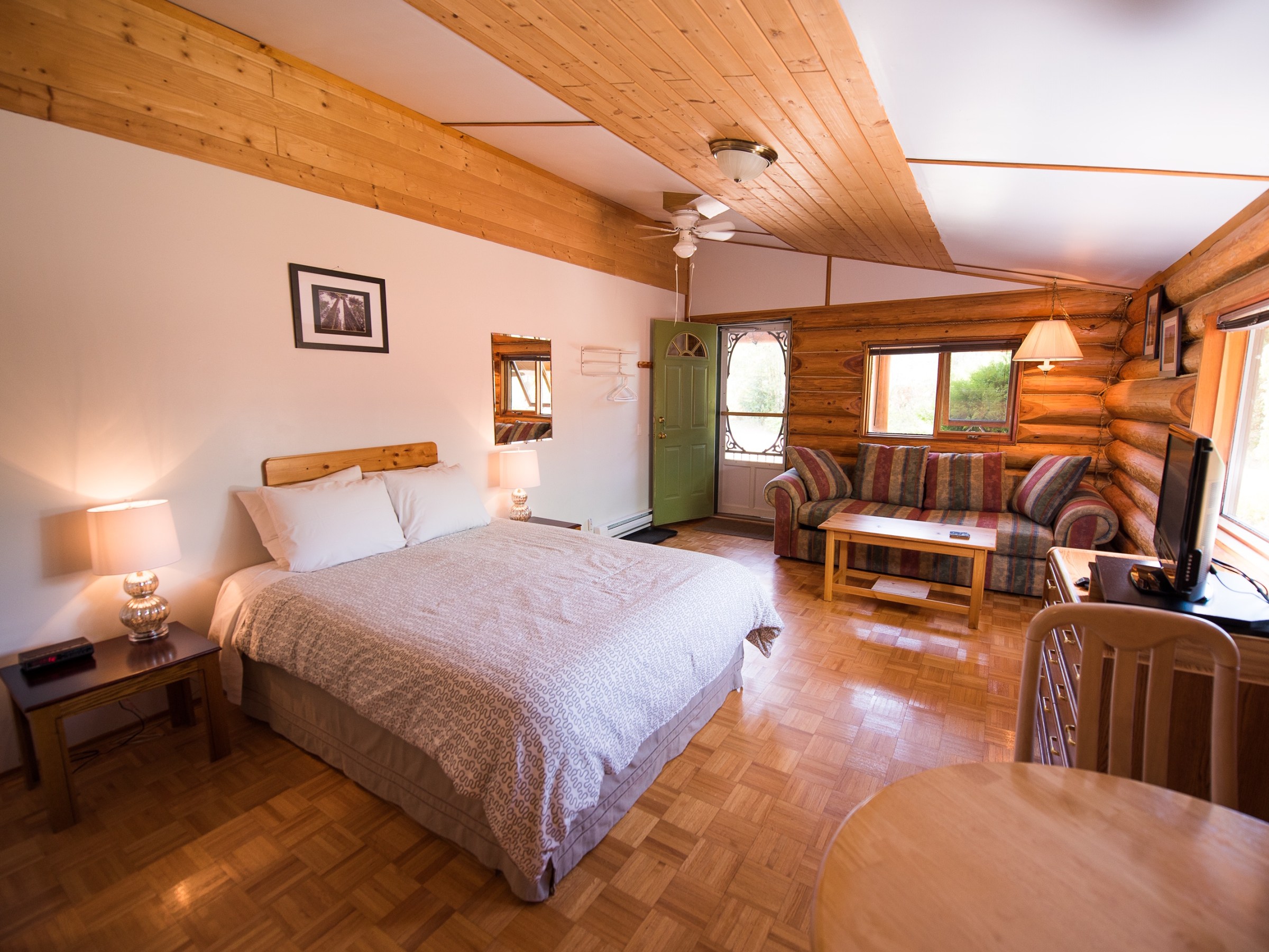 a bedroom with a bed and a chair in a room