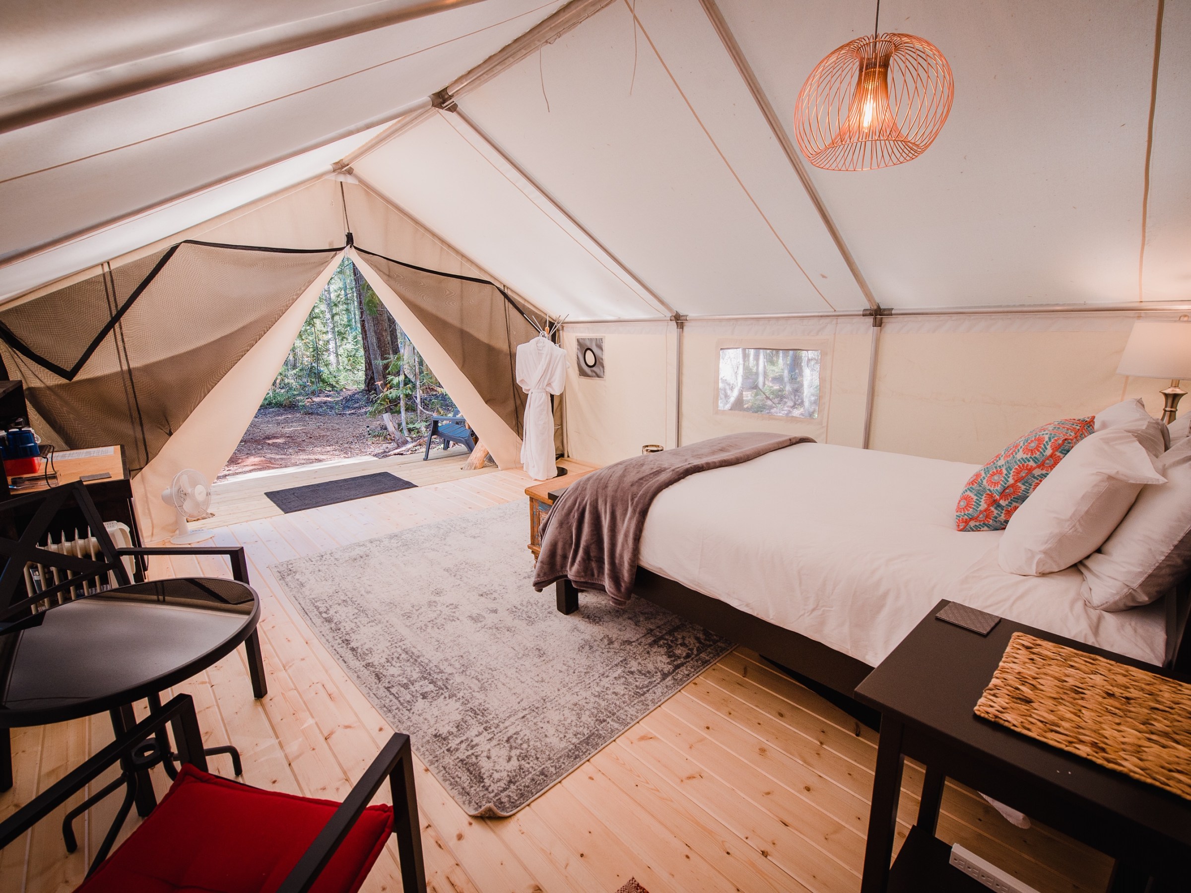 a bedroom with a bed and a chair in a room